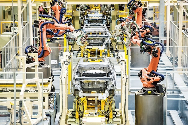 發(fā)展新能源汽車是我國從汽車大國邁向汽車強(qiáng)國的必由之路。2022年中國新能源汽車產(chǎn)銷分別實(shí)現(xiàn)705.8萬輛和688.7萬輛，連續(xù)8年位居世界第一。圖為廣汽埃安第一智造中心焊裝車間正在熱火朝天地生產(chǎn)。 廣汽埃安新能源汽車股份有限公司供圖