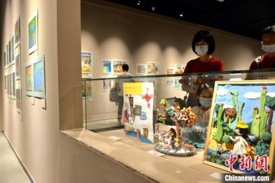 圖為家長帶著孩子參觀展覽。呂明 攝