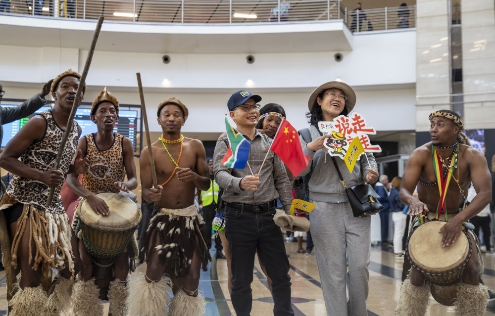 在南非約翰內(nèi)斯堡坦博國際機(jī)場(chǎng)，南非舞蹈演員歡迎中國試點(diǎn)恢復(fù)出境團(tuán)隊(duì)旅游后首批抵達(dá)南非的中國游客（2023年3月29日攝）。