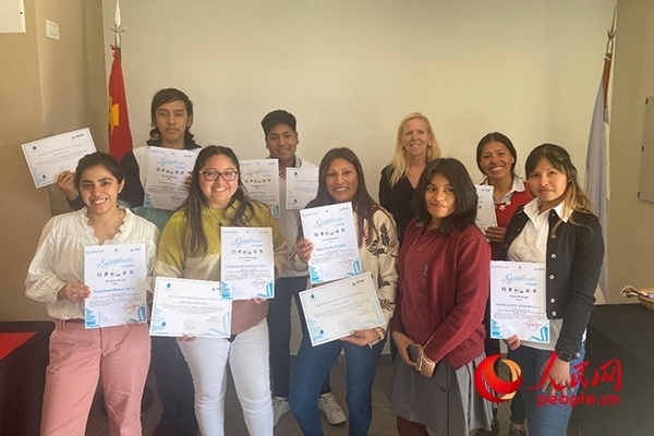 社區(qū)工作專家莫伊拉（后排右二）向“中文工坊”第二期培訓班部分結(jié)業(yè)學員頒發(fā)由薩爾塔省教育部簽發(fā)的結(jié)業(yè)證書。人民網(wǎng)記者 吳思萱攝