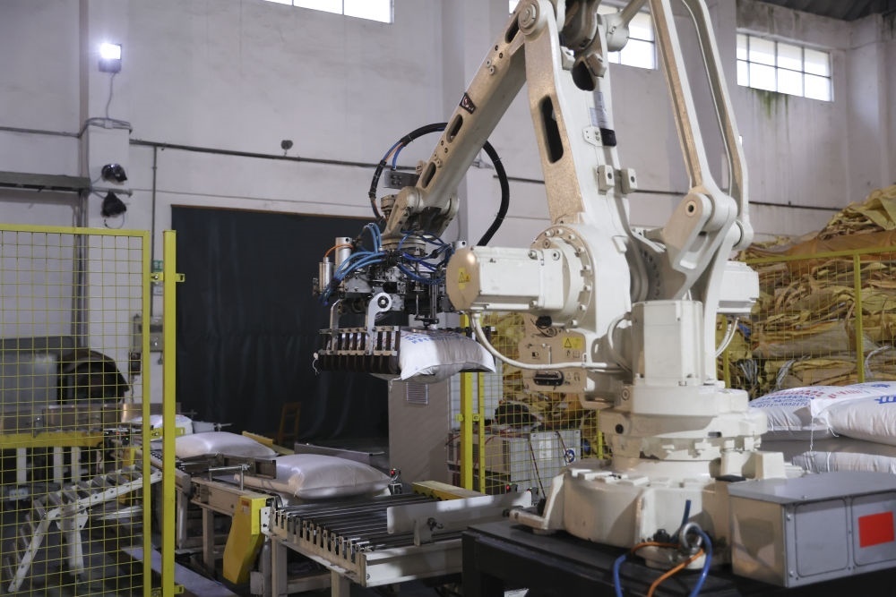 12月14日，在廣西來賓東糖鳳凰有限公司，機(jī)械臂在廠房碼放白砂糖成品。