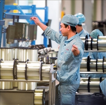 在位于武漢的長飛光纖光纜股份有限公司光纖生產(chǎn)車間內(nèi)，工作人員對(duì)光纖進(jìn)行檢測(cè)（資料圖片）。肖藝九攝/本刊