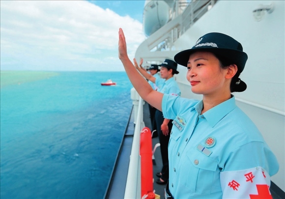 中國海軍“和平方舟”號醫(yī)院船結(jié)束訪問湯加時(shí)，任務(wù)官兵中的文職人員向歡送人群揮手告別（2023年8月4日攝）。徐巍攝/本刊