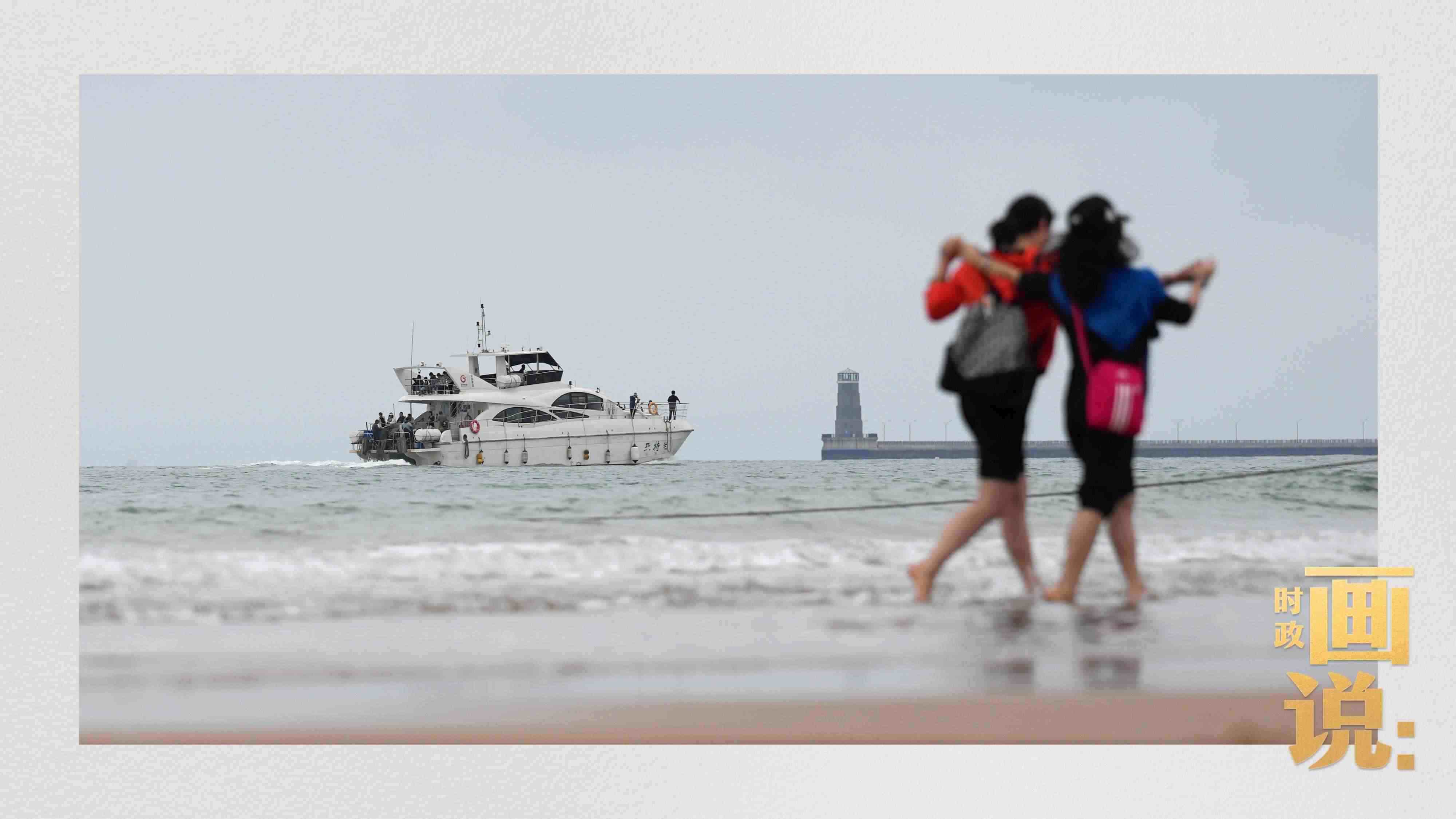 △日照陽光海岸綠道上的萬平口景區(qū)，一對游客在海浪中翩然起舞。
