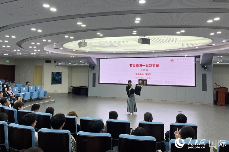 日本大學(xué)生介紹能樂(lè)知識(shí)。人民網(wǎng)記者 陳思攝