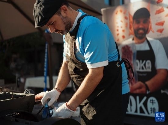 7月19日，在蕪湖古城，馬丁在當天舉行的啤酒節(jié)上制作牛排。新華社發(fā)（繆雨晨 攝）