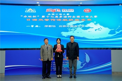 中國翻譯協(xié)會副會長中國外文局中東歐與中南亞傳播中心（人民畫報(bào)社）主任姜永鋼（右一）、原中國教育工會全國委員會巡視員白立文（左一）為獲得日語交傳組一等獎的北京外國語大學(xué)廖君怡頒獎（主辦方提供）