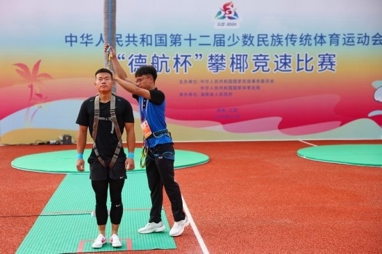 11月23日，工作人員為上海隊選手付樂樂（左）系安全繩。新華社記者 楊植森 攝