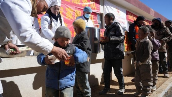 1月14日，廚師們正在給前來(lái)用餐的小朋友們打飯。新華社記者 邱星翔 攝