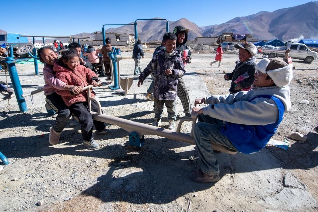 1月11日，在定日縣措果鄉(xiāng)塘仁村安置點(diǎn)，西藏星光社會(huì)工作服務(wù)中心志愿者和孩子們一起玩耍，進(jìn)行災(zāi)后心理疏導(dǎo)。人民網(wǎng)記者 翁奇羽攝