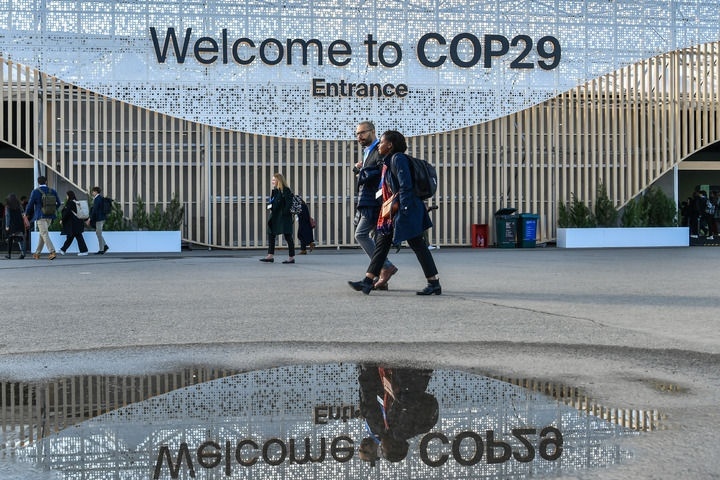 2024年11月15日，在阿塞拜疆首都巴庫，人們經(jīng)過聯(lián)合國氣候變化巴庫大會的會場。新華社記者 曹陽 攝