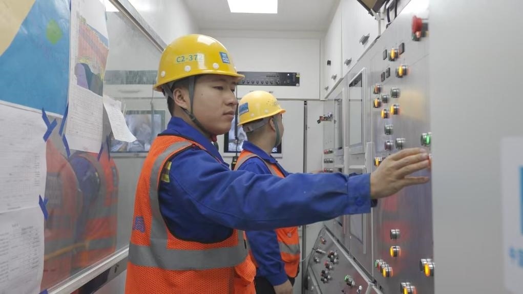 盾構司機何曉波在駕駛室內(nèi)調(diào)試盾構機參數(shù)。（劉芬攝）