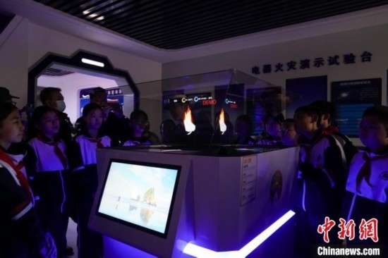 圖為學(xué)生們參觀道里區(qū)消防救援大隊消防科普體驗館內(nèi)幻影成像燃燒三要素實驗臺。中新社記者 趙宇航 攝